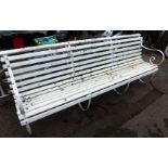 A cast iron and white painted three sectional garden bench, with arched back, 85cm high, 235cm wide,