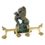 A Victorian brass door stop, cast as a rampant lion, 32cm high, and two brass andirons, 20cm