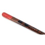 An early 20thC Anglo Indian red and black lacquer walking cane, decorated to the shaft with repeatin