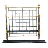 A Victorian metal framed double bed, with black and brass bulbous fittings, and a slatted base with