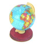 An early 20thC Chad Valley tin plate child's terrestrial globe, 20cm high.