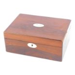 A Victorian rosewood sewing box, with oval mother of pearl escutcheon and shield, with a fitted and