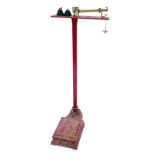 A set of W and T Avery Limited red painted cast iron balance scales, with weights, 134cm high.