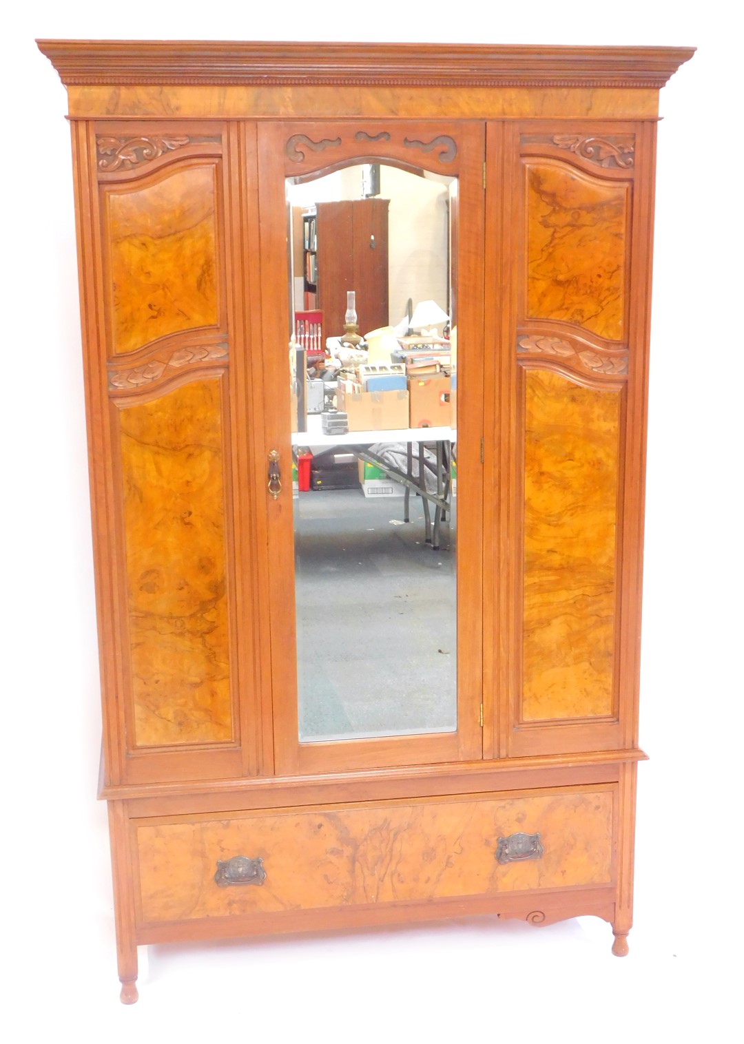 A Victorian mahogany and walnut double wardrobe, the outswept pediment with a dentil moulding, above