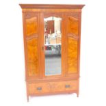 A Victorian mahogany and walnut double wardrobe, the outswept pediment with a dentil moulding, above
