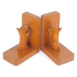 A pair of 1930s wooden bookends, each carved with a terrier, 15cm high, 12cm wide. (2)