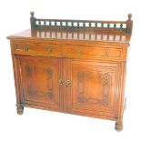 A Victorian oak sideboard, with a galleried back over two drawers, above a pair of carved panelled d