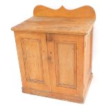 A Victorian pine kitchen cupboard, with a shaped back, above two doors opening to reveal a long draw
