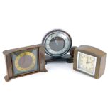 Three Art Deco mantel clocks, comprising an oak and silver rimmed numeric Metamec mantel clock, 21cm