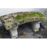 A reconstituted stone garden bench, with curved seat, on scroll supports, 44cm high, 93cm wide, 40cm