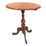A Victorian mahogany tilt top occasional table, raised on a baluster turned column, over three cabri