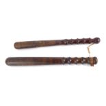 Two turned wooden police truncheons, 39cm wide.