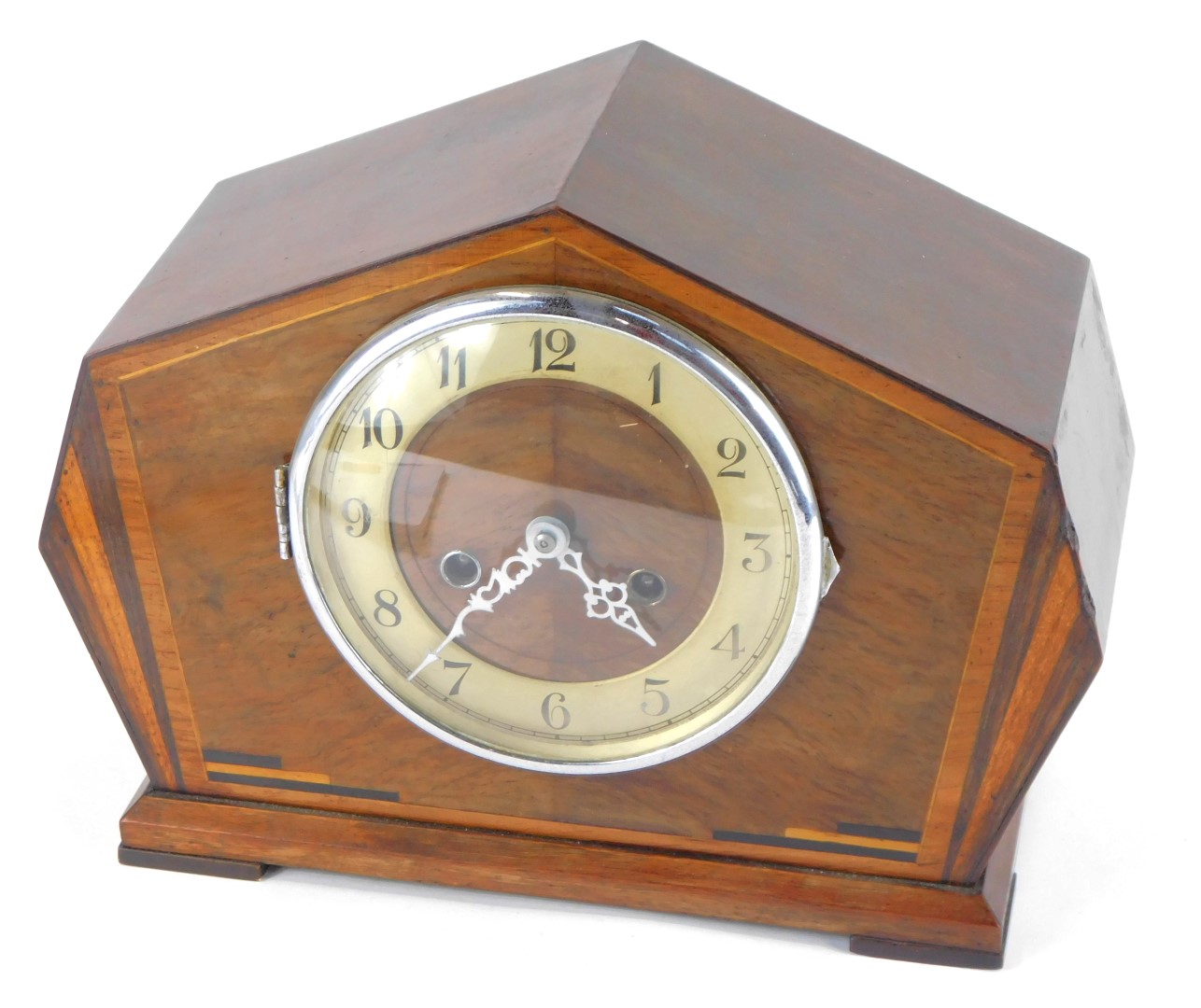 A 1950s Art Deco style walnut cased mantel clock, with a moulded case with fan banding, cream dial b