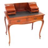 An early 20thC mahogany lady's Carlton House style writing desk, with two lift up stationery compart