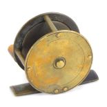 A brass miniature fishing reel, with a bone handle, unsigned, 6.5cm diameter.