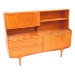 An S Form teak sideboard, the top with a drop down drinks cabinet, flanked by a single shelf, over t