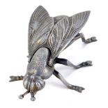 A novelty metal fly box, with a hinged winged body, 19cm diameter.