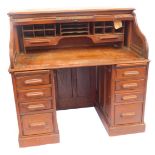 A Victorian oak tambour fronted office desk, the tambour front opening to reveal two drawers and rec