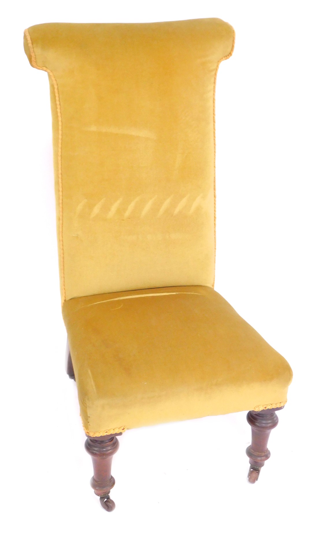 A Victorian mahogany prie dieu chair, upholstered in gold draylon, raised on turned legs, brass capp