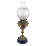 An early 20thC brass oil lamp, with a circular frosted shade, with etched floral decoration, with ch