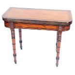 A George IV mahogany fold over card table, with rosewood cross banding and brass inlay, raised on tu