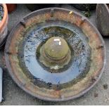 A cast iron metal Mexican hat feeding trough, 70cm diameter.