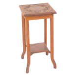 A Victorian Arts and Crafts style oak jardiniere stand, the square top carved with repeating bird's