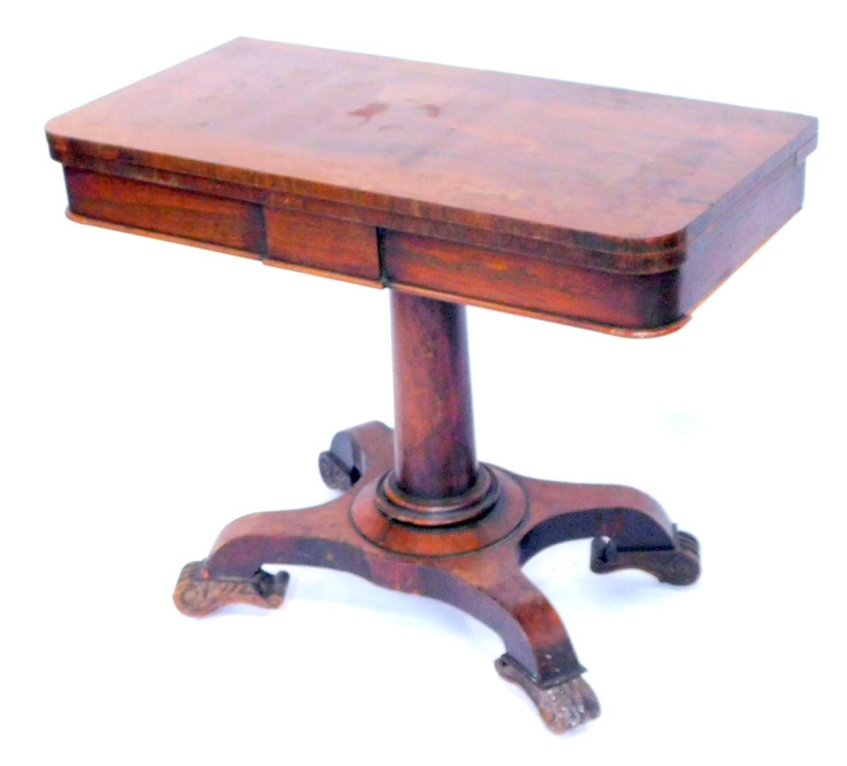 A Regency rosewood fold over card table, raised on a tapering cylindrical column over a quatrefoil b