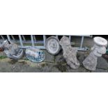 A group of reconstituted stone garden ornaments, comprising planter, reclined gentlemen, and two cot