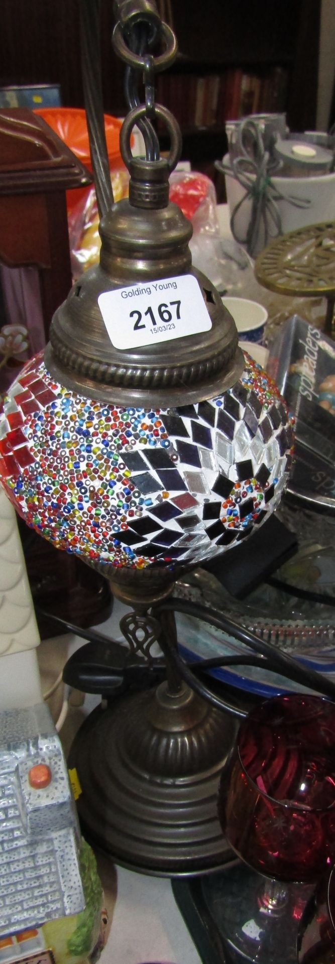A Turkish table lamp, with a domed shade, applied with sequins and beads.