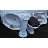 Bathroom pieces, comprising sink and pedestal, toilet, and additional sink.