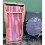 Two striped deck chairs, a glass patio table, and two chairs. (5)