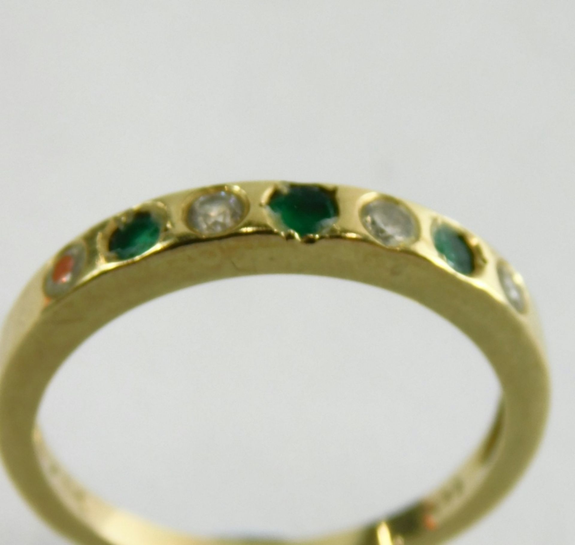 An emerald and diamond half hoop dress ring, set with three emeralds and four diamonds, each in an i - Image 2 of 4