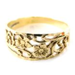A 9ct gold dress ring, of half hoop design with pierced design of flowers, ring size R, 2.4g all in.