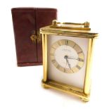 A Looping fifteen jewel eight day travel clock, of rectangular form with swing handle, 4cm diameter