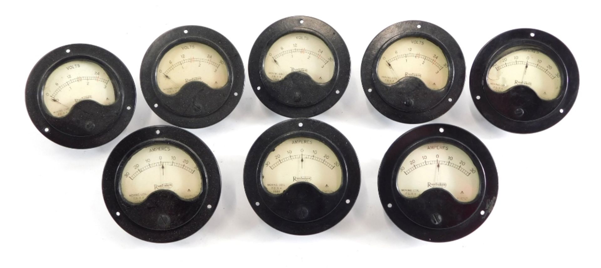 Various vault and amp dials, in Bakelite cases, one marked Rumbaken, 8cm diameter, etc., various oth