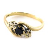 A 9ct gold sapphire and diamond twist ring, set with round brilliant cut sapphire, flanked by two il