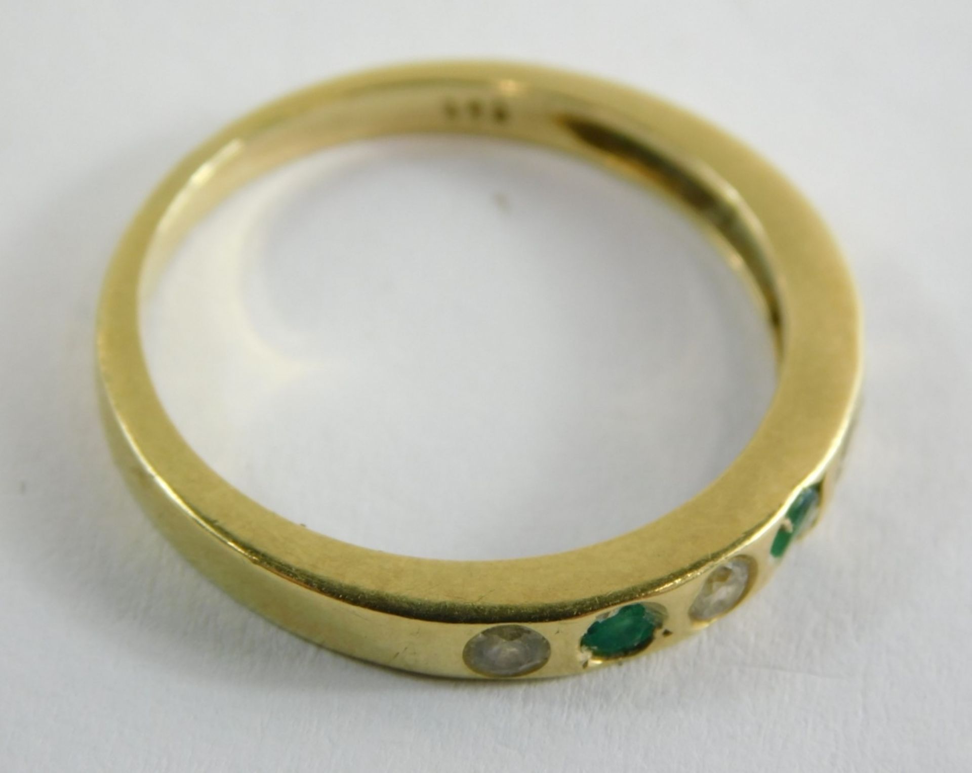 An emerald and diamond half hoop dress ring, set with three emeralds and four diamonds, each in an i - Image 4 of 4