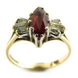 A 9ct gold garnet and cz set dress ring, in the Art Deco style with marquise shaped central garnet f