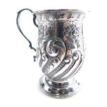 An Edwardian silver mug, by B Worth and Sons, with bell shaped body, ear shaped handle, repousse dec