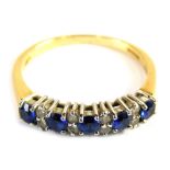 An 18ct gold sapphire and diamond half hoop dress ring, set with five round brilliant cut sapphires,