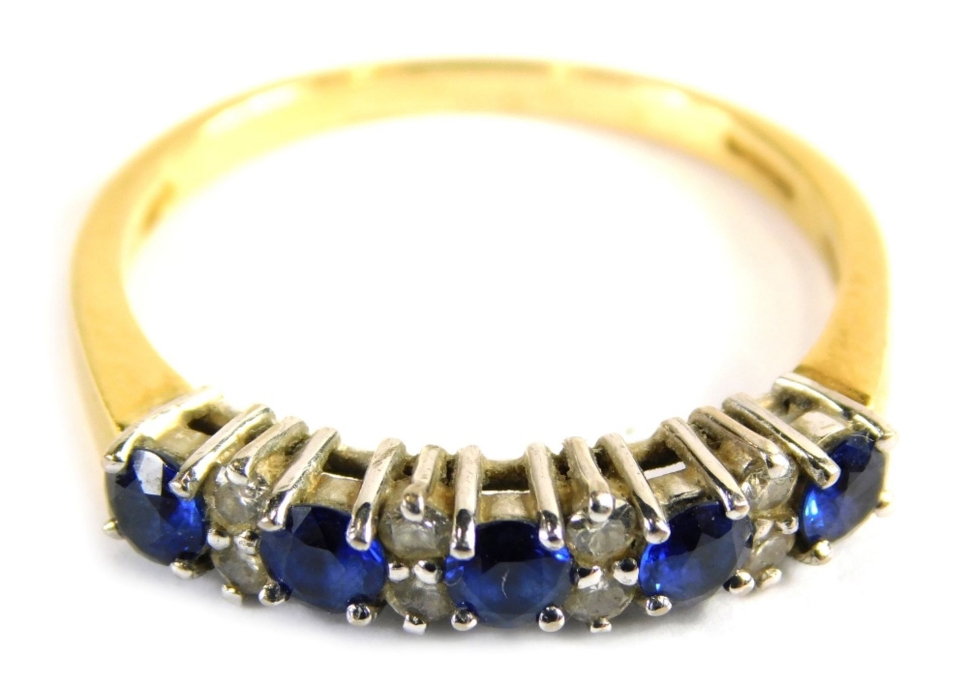 An 18ct gold sapphire and diamond half hoop dress ring, set with five round brilliant cut sapphires,