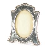 An Edward VII silver photograph frame, with oak easel back and plain oval centre, Birmingham 1910, 2