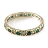 An eternity ring, set with emerald and diamond, white gold set marked 375, ring size M½, 2.3g all in