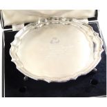 An Elizabeth II silver salver, by Butts and Dore Ltd, with piecrust edge on quadruple scroll feet, e