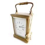 An early 20thC brass carriage clock, the 6cm wide plate stencilled with a Roman numeric dial and mar