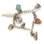 A silver charm bracelet, with curb link bracelet set with seven charms, safety chains and padlock, 1