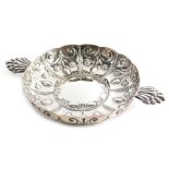 An Edward VII silver dish, by Wakeley and Wheeler, repousse decorated with panels of flowers, with a