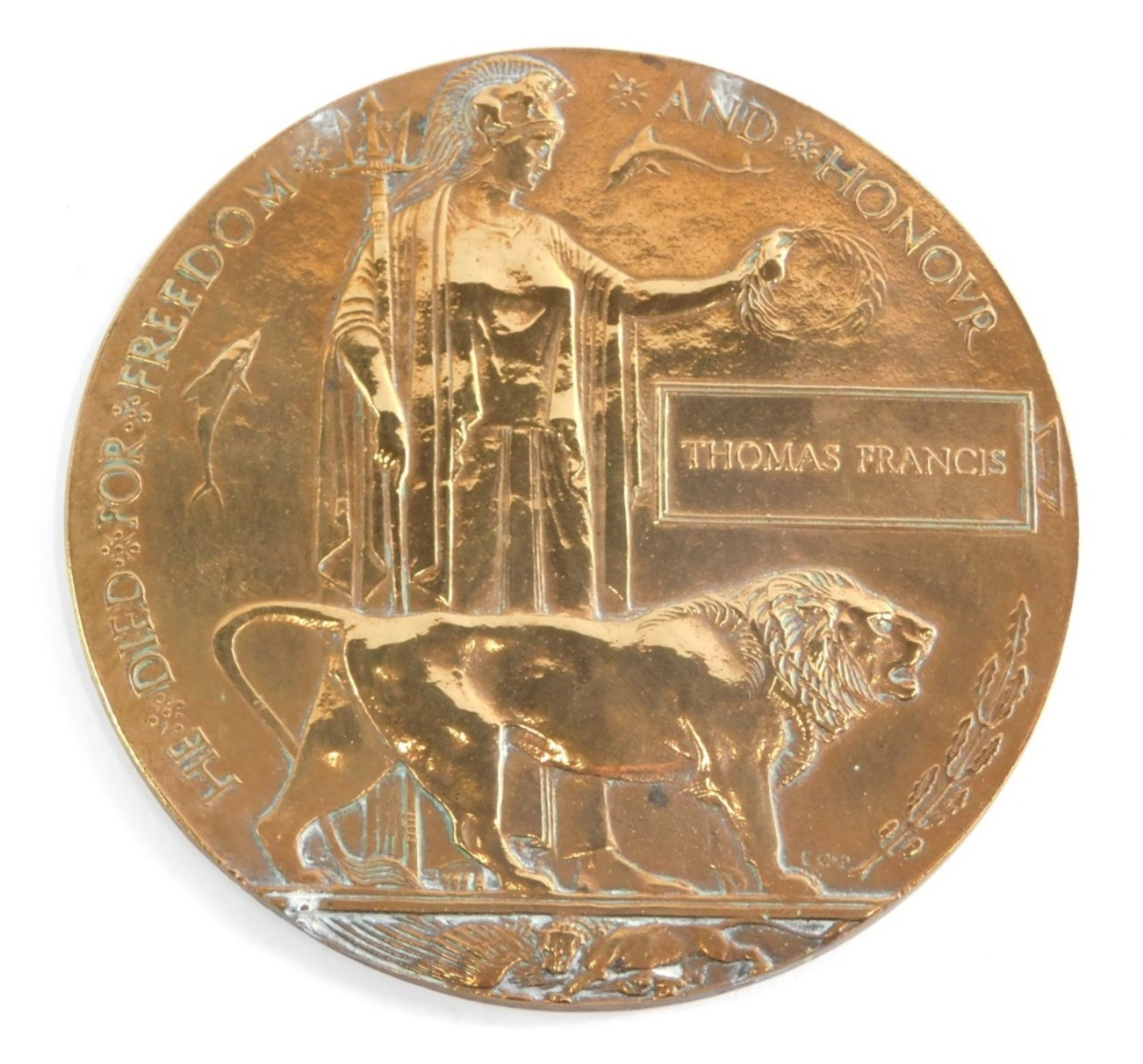 A World War I death plaque penny, marked Thomas Francis, 12cm diameter.