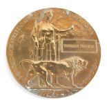 A World War I death plaque penny, marked Thomas Francis, 12cm diameter.